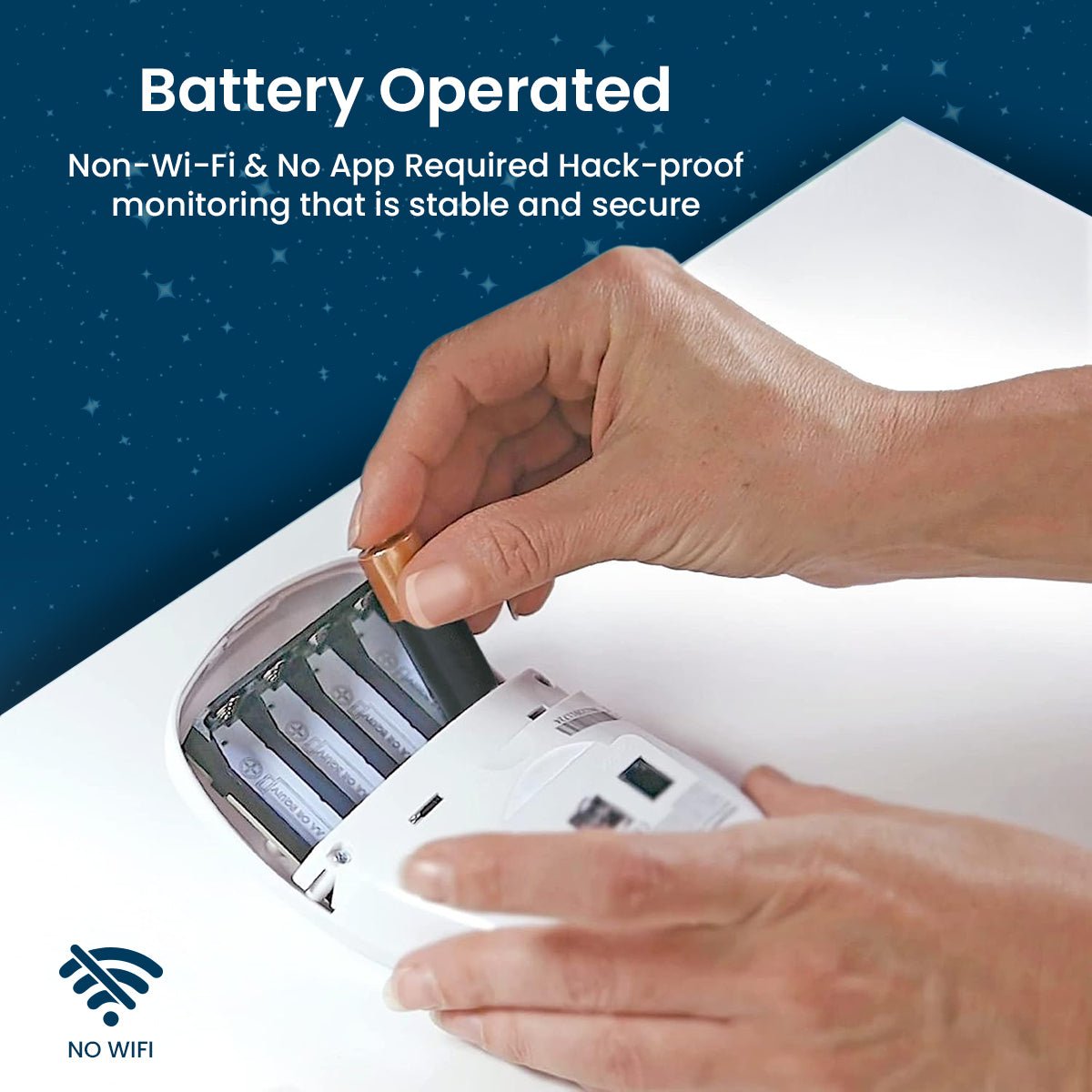 A hand inserts a battery into the white Babysense 8, a battery-operated baby monitor that is stable, secure, and hack-proof