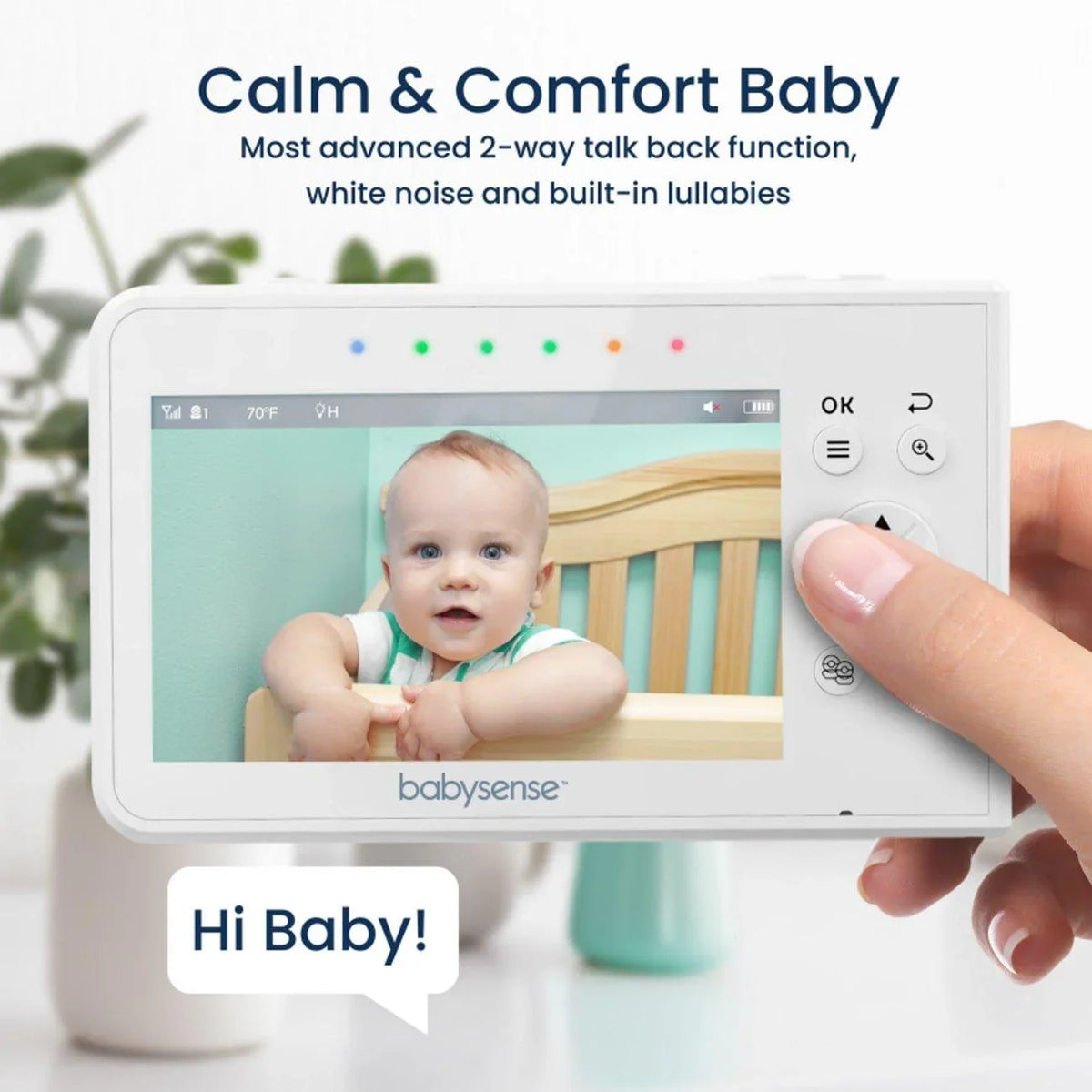 A person holds the white Babysense V43 video baby monitor with 2 cameras, displaying a baby in a crib on its screen, and "Hi Baby!" in a speech bubble