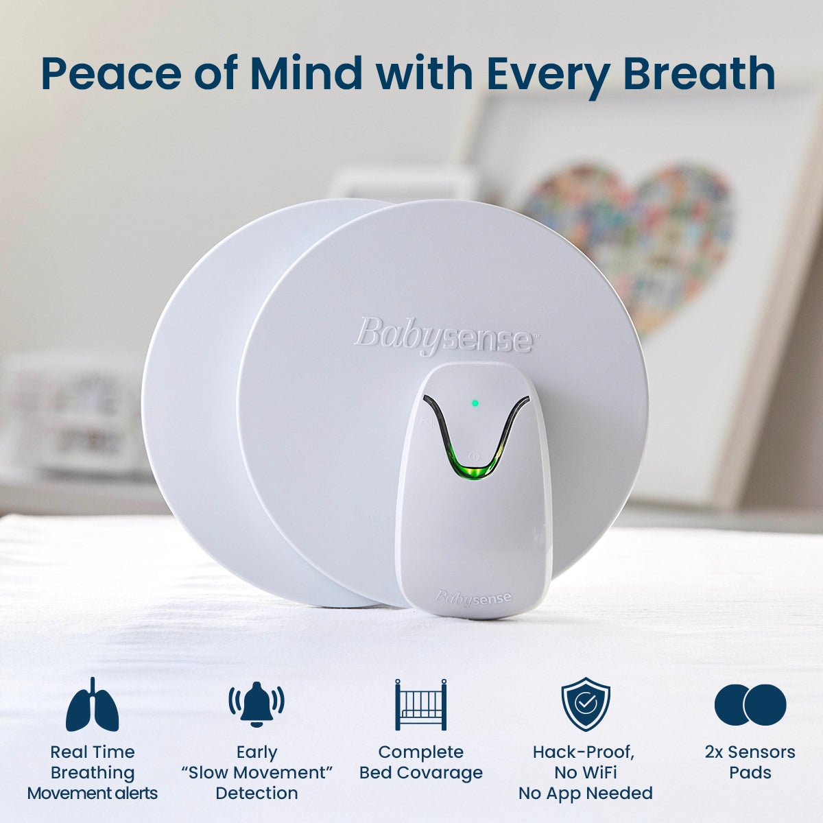 The Babysense HOME 2-in-1 Monitoring Set, a white sensor pad system with a small control unit that boasts a green indicator light and is a great home security baby monitor