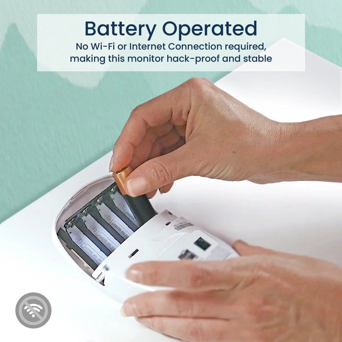 A person inserts AA batteries into the bottom of a white Babysense 7 & V24 video baby monitor, emphasizing it is a hack-proof baby monitor that does not require Wi-Fi